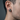 Side view of men's laurel wreath stud earring showing two-tone oxidized silver and gold design worn on the ear