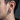 Side profile of male model wearing the oxidized silver snake hoop earring showing scale texture details