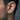 Close-up side profile of a man wearing the architectural beaded hoop earring highlighting its comfortable secure fit.