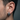 Side profile of a man wearing the chunky gothic skull hoop earring showing the secure hinged closure fit