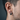 Male model wearing the oxidized silver cuneiform hoop earring demonstrating the 14mm thick circular band scale and fit.