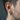 Close-up of oxidized silver Greek key hoop earring worn by male model showing 14mm diameter and hinged closure