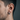 Side profile view of industrial hoop earring worn by a male model highlighting the matte finish and snug fit.