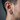 Close-up of modern industrial hoop earring in oxidized silver worn comfortably on a male model's ear for everyday style