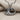 Close-up of the oxidized silver ocean wave pendant showing the stylized curved wave design resting on textured fabric