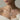 Elegant woman wearing a sterling silver hand fan pendant necklace styled over an off-shoulder sweater for a graceful look