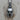 Angled close-up of warrior helmet necklace design featuring intricate crest and eye slits