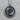 Close-up of the sterling silver koi fish pendant resting on a wooden surface showing intricate oxidized metalwork