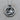 Close-up of the premium 925 silver Capricorn zodiac pendant resting on a natural wooden surface showing metal texture.