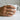 Bypass wave ring worn on model hand holding mug