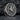 Close-up of Yatagarasu crow ring resting on dark stone highlighting the kanji engraving and deep oxidized finish