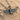 Oxidized silver Egyptian Isis goddess pendant with intricate headdress resting elegantly on textured sand