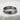 Close-up of solid sterling silver kanji eternity ring resting on textured stone highlighting the oxidized engraving.