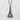 Close-up of Tokyo Tower pendant on textured white background highlighting deep oxidation and polished finish.