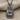Teshub Storm God Pendant, oxidized silver finish, front view on fabric
