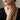 Woman wearing gold plated praying hands ring on ring finger with elegant black outfit close up view