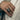 Men's hand wearing the striking oxidized silver Taurus bull ring showcasing scale, depth, and bold statement styling