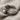 Close-up of the handcrafted twin skull ring highlighting the oxidized silver finish resting on textured linen