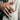 Man wearing handcrafted oxidized silver Maltese cross signet ring on index finger with cream linen suit