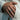 Man wearing handcrafted oxidized silver polar bear wedding band paired with a cream linen suit jacket