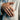 Man wearing handcrafted Nordic bird ring on ring finger styled with elegant light linen blazer for suit attire