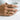 Interlocking holding hands ring in gold vermeil, worn on model hand holding a mug