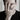 Lifestyle view of a man wearing a silver wolf signet ring on his finger in a stylish portrait setting