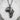 Close-up detail of the majestic lions carved into the sterling silver African continent pendant with oxidized finish.