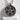 Garnet Seed Pomegranate Pendant in oxidized silver, front view on display pedestal