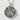 Oxidized silver floral pentacle pendant resting flat on a textured white stone surface highlighting the woven star