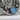 Close-up of the oxidized silver Hecate crescent pendant highlighting the intricate floral metalwork and blue stone