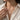 Woman wearing handcrafted Aquarius zodiac pendant chain necklace with elegant linen shirt model view
