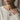 Model wearing oxidized silver Scorpio zodiac necklace over a white sweater in a close-up lifestyle view
