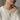 Model wearing delicate gold engraved aster flower bar pendant necklace with cozy white knit sweater outfit