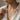 Model wearing a minimalist gold larkspur birthstone pendant vertical bar necklace with white open-collar shirt