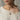 Woman wearing handcrafted garnet solitaire pendant necklace on delicate chain over cream knitted sweater