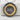 Close-up of two-tone gold vermeil snake ouroboros pendant resting on a rustic white textured stone background