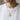Lifestyle model wearing handcrafted Mexican eagle pendant coin necklace against plain background