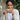 Woman holding a white coffee cup while wearing the dainty Mayan jade ring in a natural outdoor setting
