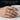 Lifestyle view of detailed handcrafted dragon ring worn on male hand holding a white ceramic mug