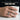 Men's hand wearing oxidized silver motorcycle tire ring while holding a white coffee cup in daily setting