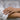 Woman wearing a dainty pearl claw ring with oxidized scale details on finger for elegant daily style