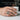 Lifestyle shot of handcrafted oxidized silver Masonic archer ring worn on hand holding a white ceramic cup