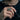Man wearing oxidized silver Eye of Horus thumb ring on hand holding sunglasses in stylish lifestyle studio shot