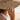 Woman wearing the sterling silver lotus open ring on her finger in a sunny beach setting wearing a straw hat