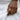 Model wearing detailed octopus ring on finger over white linen garment showing fit and wrapped tentacle design