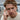 Red-haired man wearing oxidized silver wolf paw signet ring on index finger outdoors by a wooden dock