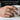 Men's hand wearing an oxidized silver Masonic tiger eye ring while holding a white coffee mug
