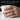 Handcrafted cracked spinner ring worn on hand holding white coffee cup showcasing smooth comfort fit edges