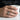 Moon rock ring in oxidized silver worn on a man's finger holding a coffee mug for daily style showcase
